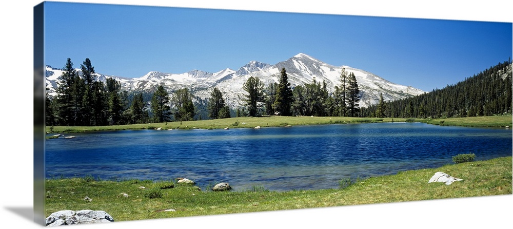 Big canvas photo of a lake with snow covered mountains in the distance.