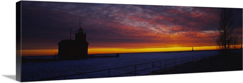 Silhouette of a light house at sunset, Big Red Lighthouse, Holland ...