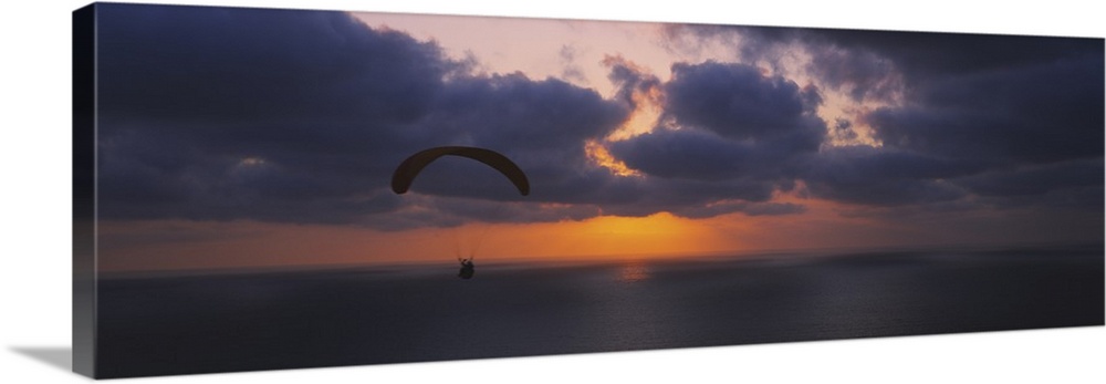 Silhouette of a person paragliding over the sea, Blacks Beach, San Diego, California