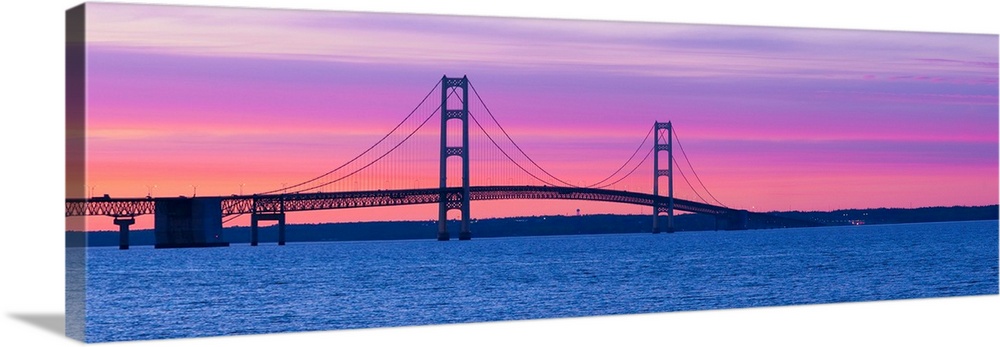 Panoramic photograph shows a long overpass spanning a large body of water and connecting two portions of a state in the Mi...