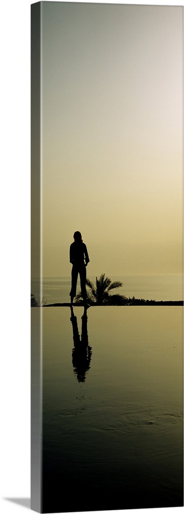 Silhouette of a woman standing at the poolside, Infinity Pool, Movenpick Resort, Jordan