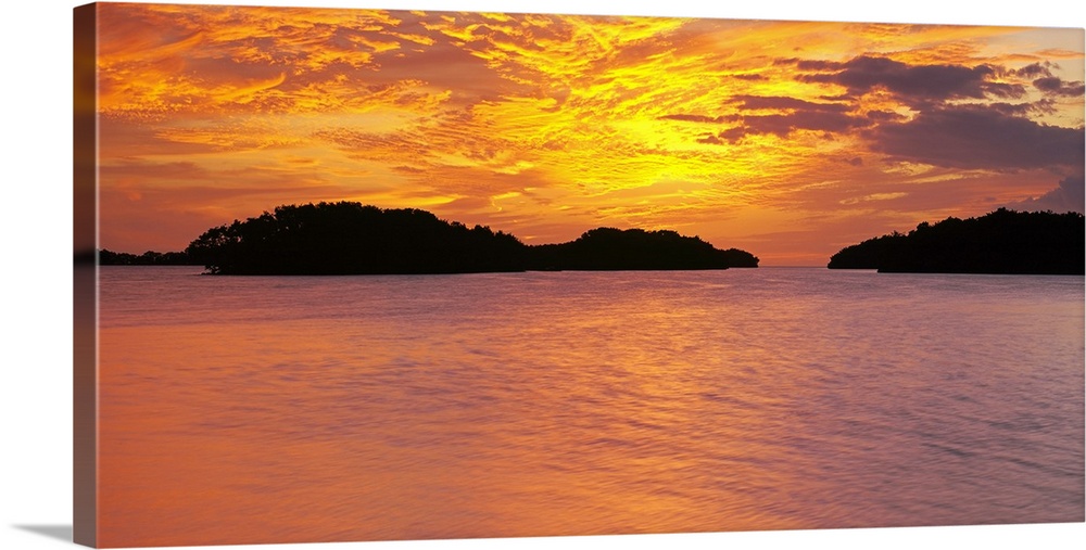 Large canvas photo of a vibrant sunset reflected in calm waters.