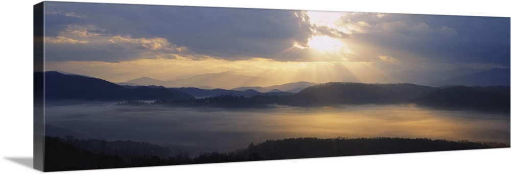Wide angle photograph of the sun rising over the mountains, and the vast landscape of the Great Smoky Mountains National P...