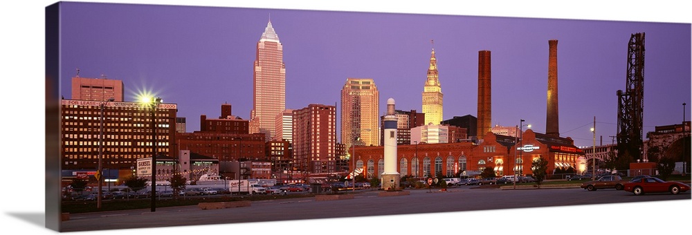 Panoramic photograph of skyscrapers in Cleveland, Ohio, lit up at night.
