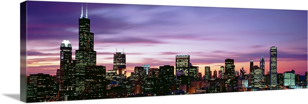 This is a panoramic photograph of a sunset behind the shining city skyline in the Midwest.