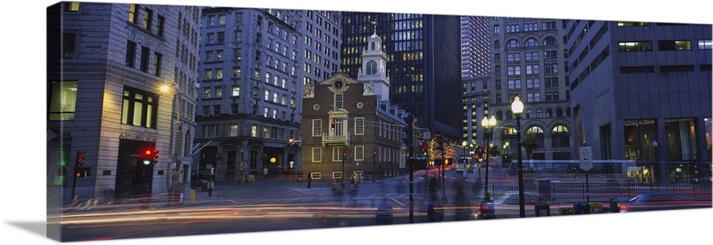Panoramic photo art of a downtown area with tall buildings illuminated at night.