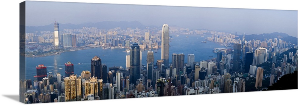 Wide angel, aerial photograph of large buildings in Hong Kong, China, surrounding Victoria Harbour.