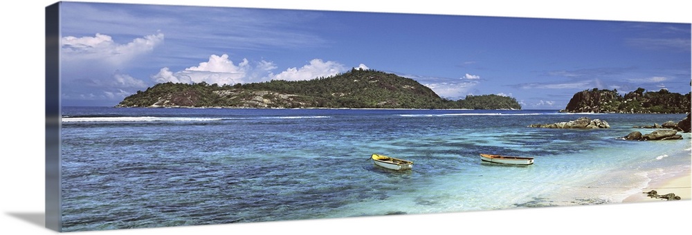 Small fishing boats on Anse L'Islette with Therese Island in background, Seychelles