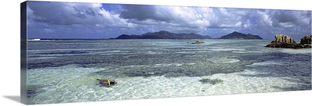 Snorkeler in the waters of Anse Source d'Argent beach, La Digue Island, Seychelles