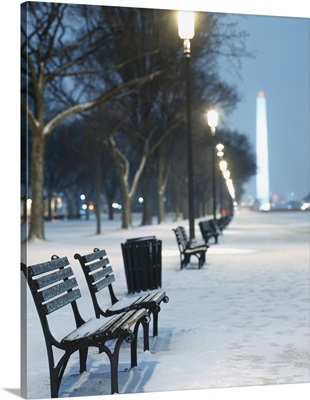 Snow covered benches along a footpath, Washington Monument in background, Washington DC