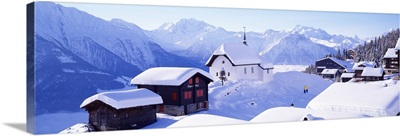 Snow Covered Chapel and Chalets Swiss Alps Switzerland