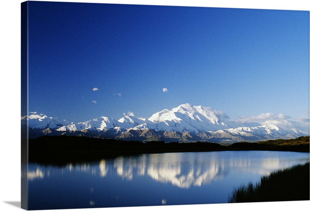Snow-covered Mount McKinley reflected in lake, blue sky, Denali National Park, Alaska