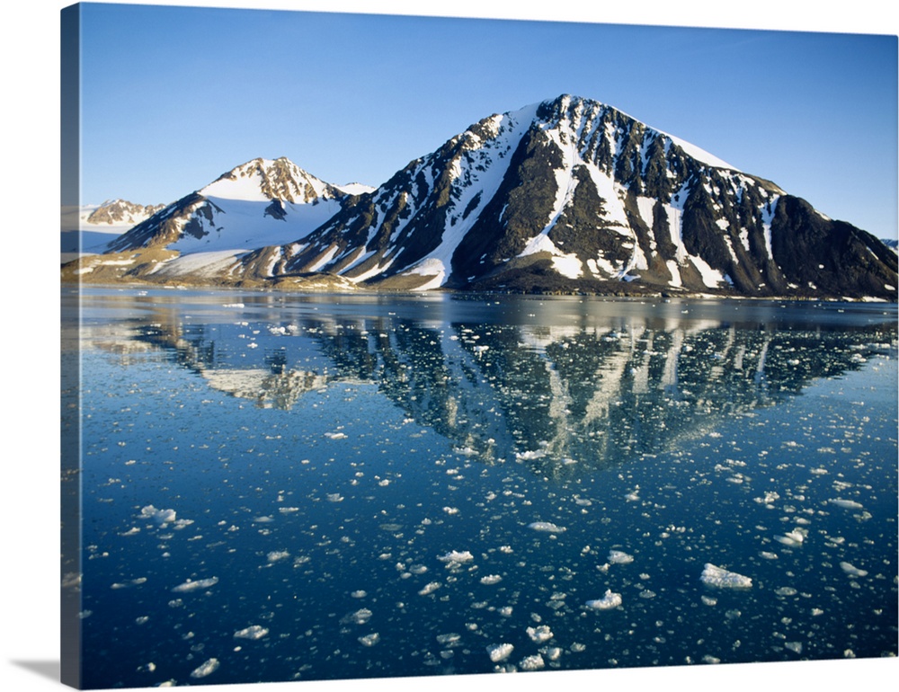 Snow covered mountain reflecting in water, Liefdefiorden, Spitsbergen, Svalbard, Norway