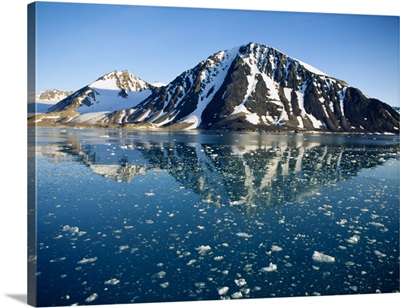 Snow covered mountain reflecting in water, Liefdefiorden, Spitsbergen, Svalbard, Norway