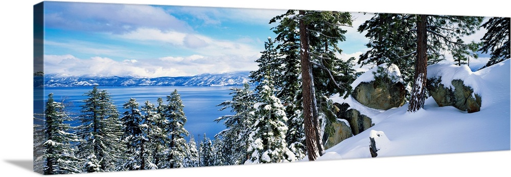 A landscape photograph taken from a mountain ridge in winter looking down into the scenic lake and wilderness.