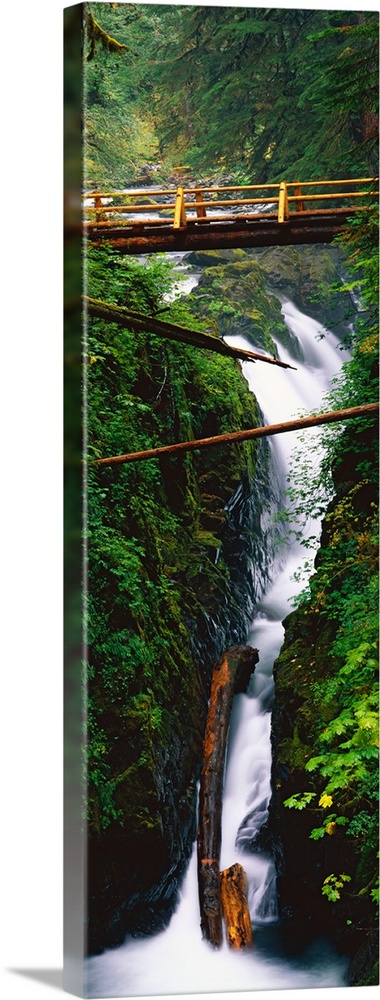 This long, vertical photograph was taken with the time lapsed technique to capture the continuous cascade of water through...