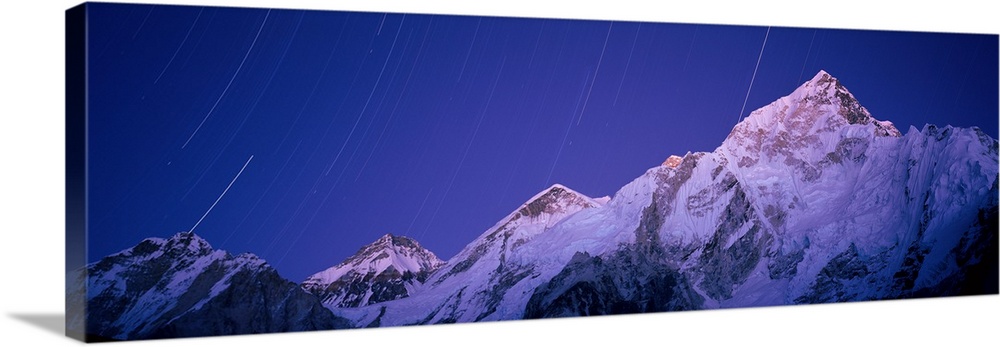 Star trails over snowcapped Nuptse and Mt Everest range, Everest Base Camp Trek, Khumbu, Nepal.