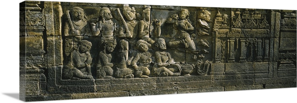 Statue carved on the wall of a temple, Borobudur Temple, Java, Indonesia
