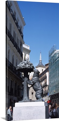 Statue of a bear and a madrono tree on the street in front of buildings, Puerta Del Sol, Madrid, Spain