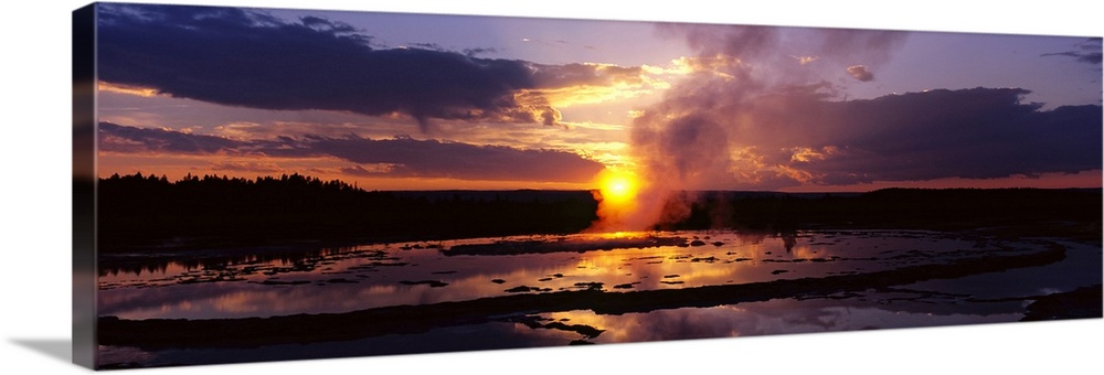 Steam emitting from a natural geyser at sunset, Yellowstone National Park, Wyoming
