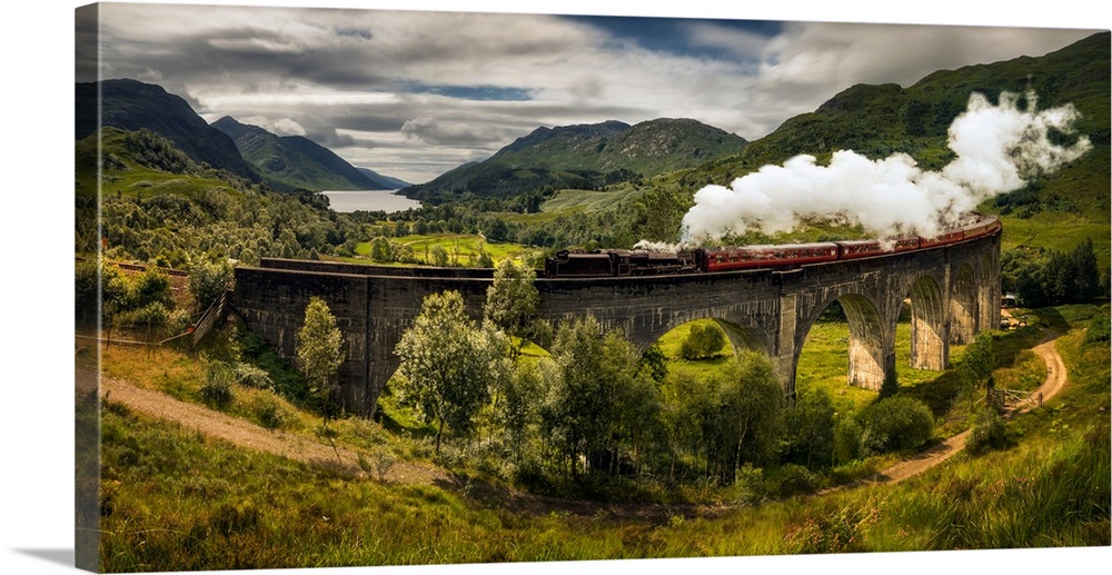 Steam train moving on old bridge, scotland.