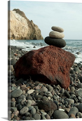 Stone balancing on a rock at the coast, Akrotiri, Santorini, Cyclades Islands, Greece