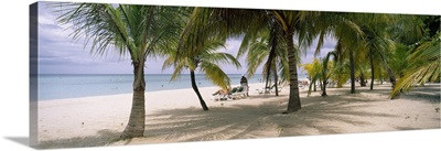 Sunning tourists on 7-Mile Beach, Negril, Jamaica