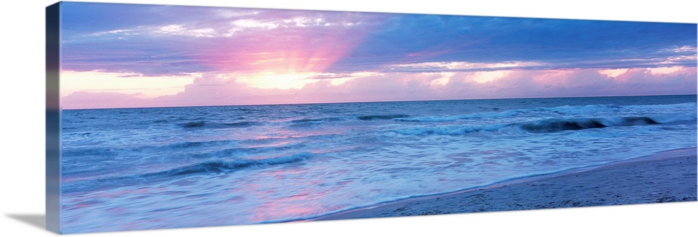 Large panoramic photo of the sun setting over a beach in Naples, Florida (FL).