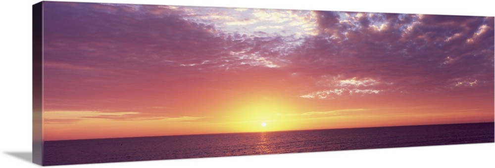 Panoramic photo of a beautiful sunset over the ocean.