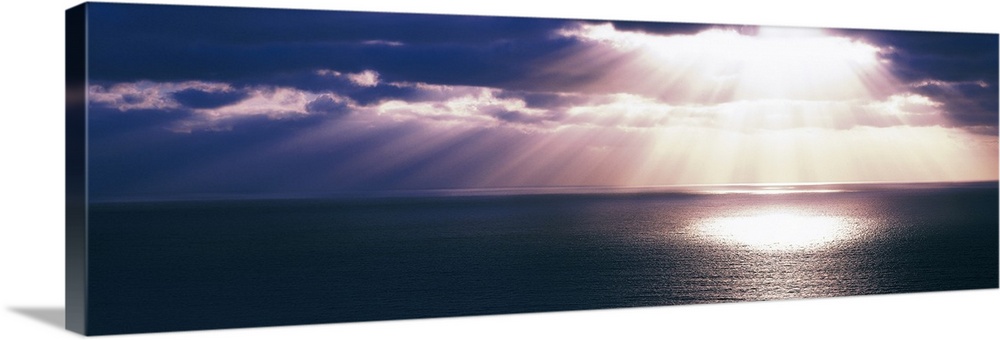Panoramic canvas photo of a sunset over the Pacific Ocean with no land in sight.