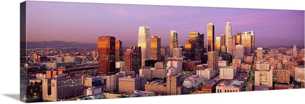 Giant horizontal panoramic photograph of the city of Los Angeles, California (CA) as the sun begins to set and its rays sh...