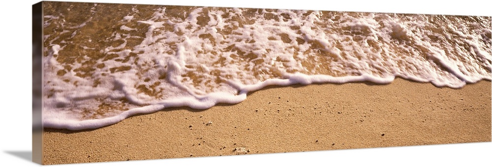 Panoramic photograph of sea spray on shoreline.