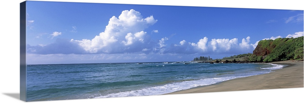 Horizontal photograph on a giant wall hanging of the shoreline along Hamoa Beach, green hills in the background, in Hana, ...