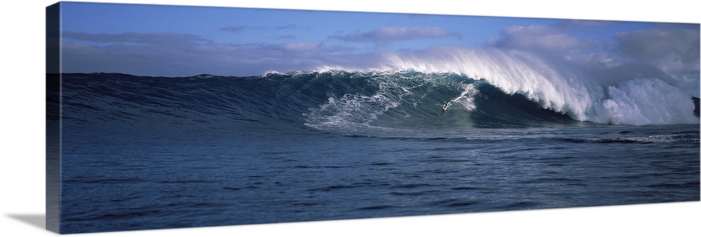 Panoramic photo of a big wave crashing in the Pacific Ocean.