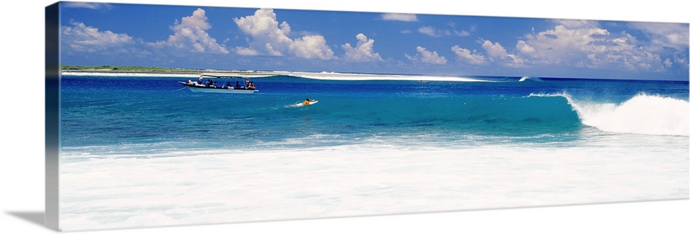 Surfer surfing in the ocean, Tuamotu Archipelago, Tahiti, French Polynesia