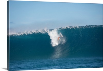 Surfer surfing wave in Pacific Ocean, Moorea, Tahiti, French Polynesia