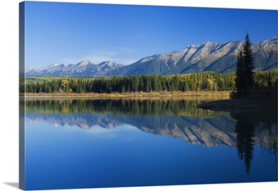 Swan Mountain Range reflecting in calm water of Rainy Lake, Seeley Swan Valley, Montana