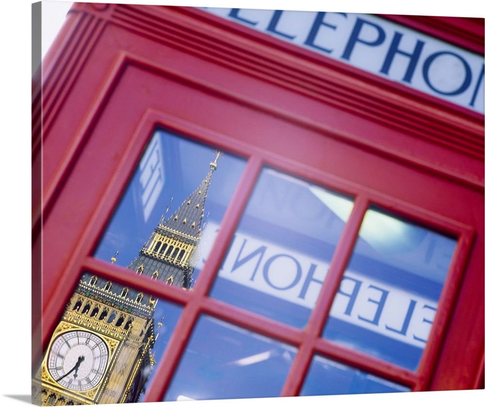 Upclose photograph of a British telephone booth in London showing the reflection of Big Ben at the north end of the Palace...