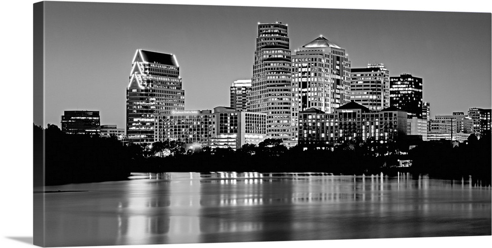 Panoramic monochromatic photograph showcases the busy skyline of a famous city within the Southwestern United States refle...