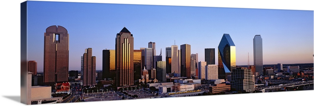 Oversized, panoramic photograph of the Dallas skyline at sunrise.