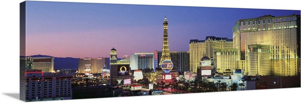 Big panoramic canvas photo of the Las Vegas Strip illuminated at sunset.
