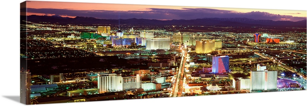 This wall art is a panoramic photograph taken from high in the air of the Sin cityos night lights glowing in the twilight.