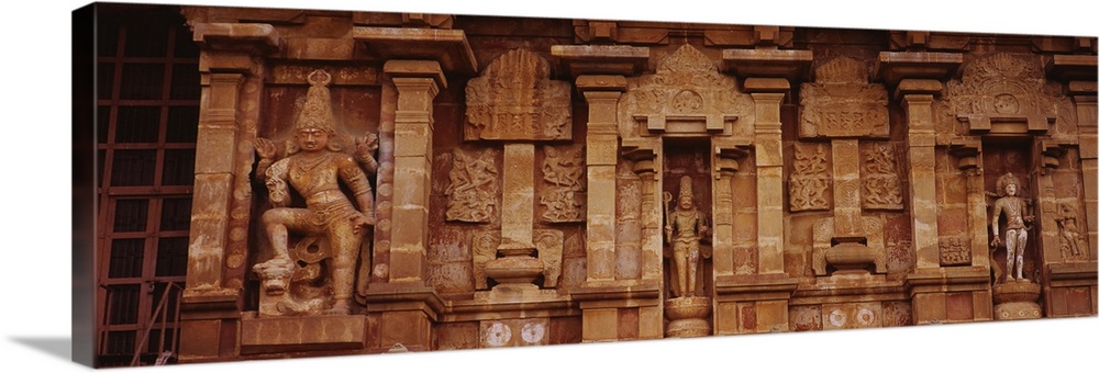 Three statues of gods carved on the wall of a temple, Tamil Nadu, India