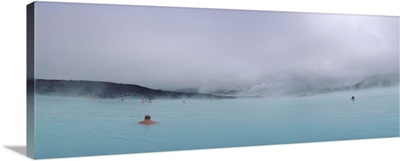 Tourist swimming in a thermal pool, Blue Lagoon, Reykjanes Peninsula, Reykjavik, Iceland