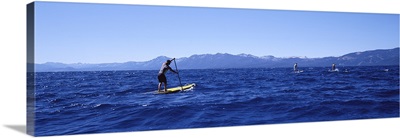 Tourists paddle boarding in a lake, Lake Tahoe, California