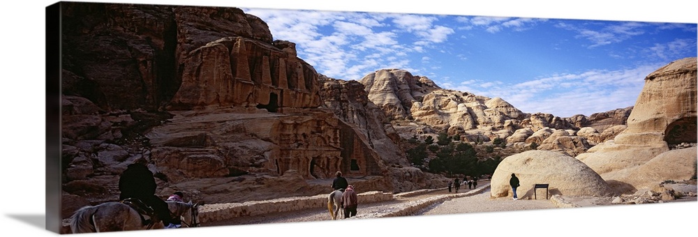 Tourists walking through ancient structures, Jordan