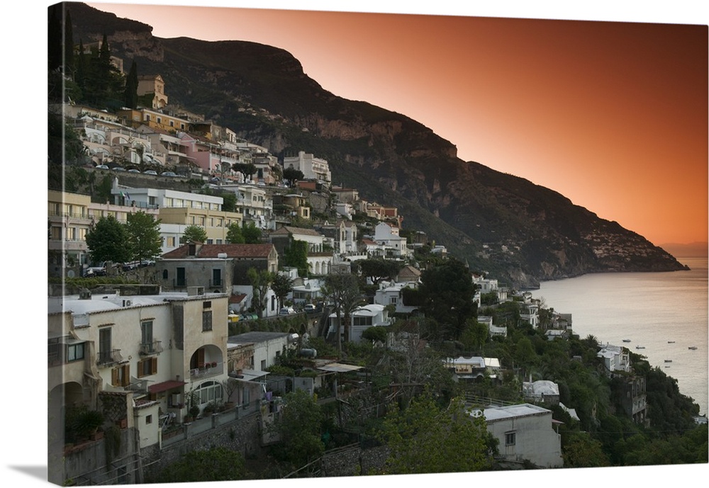 Oversized, landscape photograph of several cities in Italy on a hillside at dusk, including Positano, Salerno and Campania.