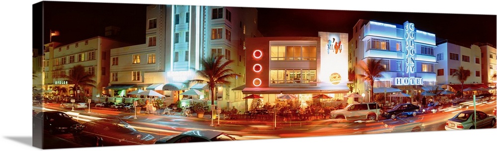 A panoramic view of the Art Deco buildings, neon lights and palm trees along Ocean Drive in Miami, Florida.
