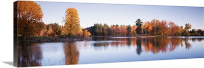 Trees in autumn along a lake, Canterbury, New Hampshire, England