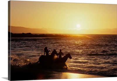 Two Anonymous Riders On Horseback Riding In Surf At Sunset Banzai Beach Hawaii